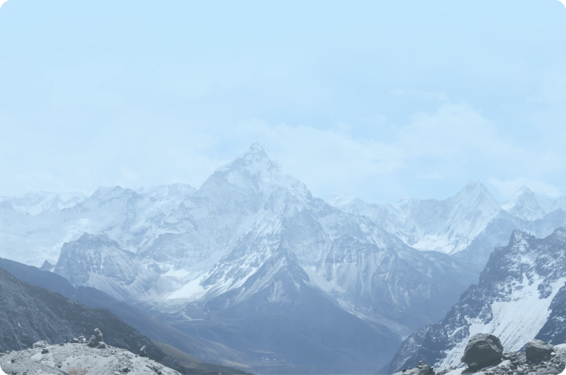 Snow-covered mountains beneath a clear blue sky